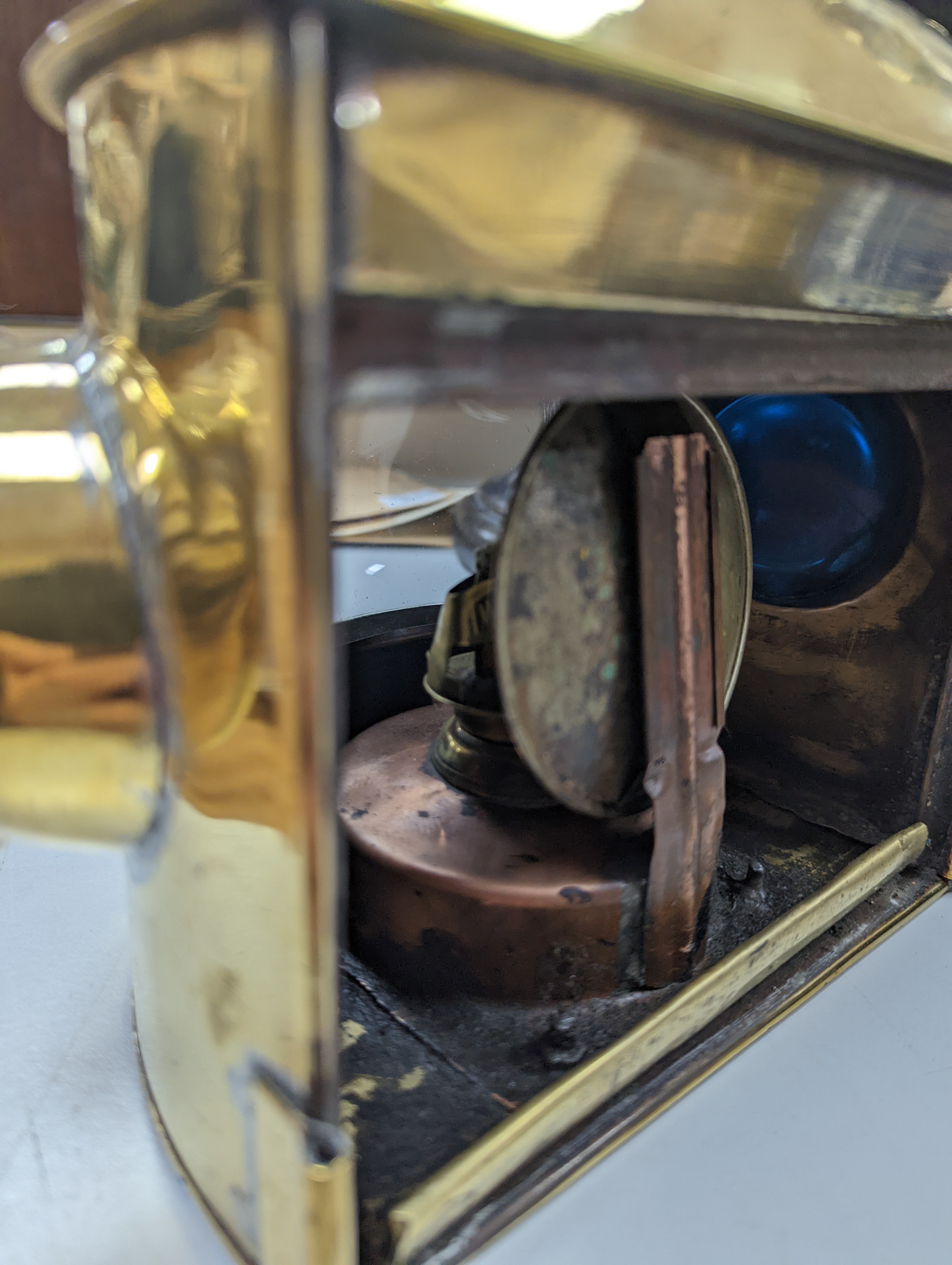 A copper ship's binnacle compass, a brass oil lamp, a brass jug and a copper kettle